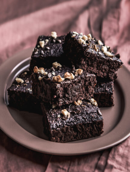 fudgy vegan brownies on a pink plate